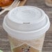 A white Dart plastic lid on a coffee cup.