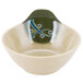 A white melamine bowl with a green and blue design and a handle.