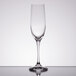 A close-up of a Spiegelau Vino Grande flute glass on a reflective surface.