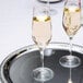 Two Spiegelau champagne flutes on a tray.