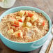 A bowl of cinnamon apple oatmeal with fruit.