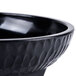 A black melamine molcajete bowl with a black rim.