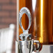 A close up of a chrome spigot handle.