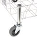 A Rubbermaid stainless steel Slim Jim dolly with wheels.
