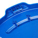 A blue Rubbermaid BRUTE lid for a round trash can with a hole.