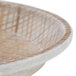 A close up of a round fiberglass tray with a woven rattan pattern.