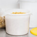 A white Rubbermaid food storage container filled with pasta.