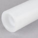 A close-up of a white plastic tube with a small hole.