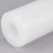 A white plastic cylinder with a small hole.