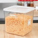 A white Rubbermaid square polyethylene lid on a container of shredded cheese.
