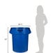 A woman standing next to a blue Rubbermaid BRUTE trash can.