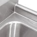 A stainless steel Advance Tabco two compartment pot sink with drains.