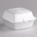 A white Dart foam food container with a hinged lid.