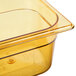 A Rubbermaid amber plastic food pan on a counter.