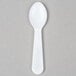A white plastic Solo taster spoon with a round handle.