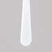 A close up of a white Solo plastic taster spoon.