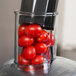 A Robot Coupe Cuisine Kit with tomatoes in a food processor.
