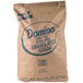 A brown bag of Domino Extra Fine Granulated Sugar with blue text.
