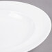 A close-up of an Arcoroc Vintage white soup plate with a white rim.