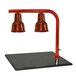 A Hanson Heat Lamps smoked copper carving station with red heat lamps over a black surface.