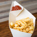 A American Metalcraft square cardboard fry cone filled with french fries and ketchup.