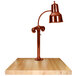A Hanson Heat Lamps smoked copper carving station with a maple block base.