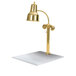 A brass Hanson Heat Lamp over a white marble base.