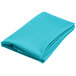 A close-up of a teal blue hemmed table cover folded on a white background.