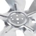 A close-up of a silver metal Avantco condenser fan blade with holes.