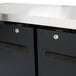 A close-up of a black cabinet with a silver lock cylinder on the door.