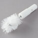 A white plastic Bar Maid shot glass washer brush with a wire.