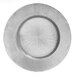 A silver Charge It by Jay glass charger plate with a circular burst design.