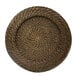 A round wicker Charge It by Jay rattan charger plate with a spiral pattern.