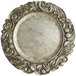 A close-up of a silver Charge It by Jay plastic charger plate with a floral design.