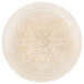 A round gold glass charger plate with an intricate design.