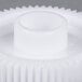 A white plastic gear with a hole.