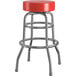 A Lancaster Table & Seating red vinyl double ring swivel bar stool with a metal base.