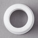 A white circular plastic bearing shaft upper bearing with a hole in the center.