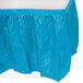 A turquoise blue plastic table skirt with ruffles.