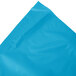 A turquoise blue plastic table skirt on a white background.