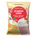 A bag of Big Train Strawberry Banana Blended Creme Frappe Mix with a picture of a banana and whipped cream on the label.
