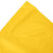 A folded School Bus Yellow plastic table skirt.