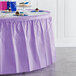 A Luscious Lavender plastic table skirt on a table with cupcakes.