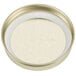 A Libbey gold metal Mason jar lid with a white surface.