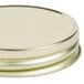 A close-up of a gold metal Libbey Mason Jar lid.