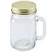 A Libbey glass Mason jar with a gold metal lid and handle.