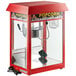 A red Carnival King popcorn machine with a clear container on top.