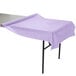 A lavender plastic tablecloth on a table outdoors.