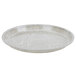 A gray Cambro round fiberglass tray with many lines on it.