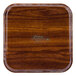 A square wooden tray with a wood grain surface.